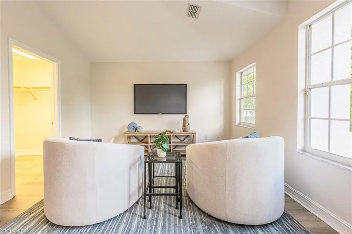 Living area with wood finished floors and lofted ceiling