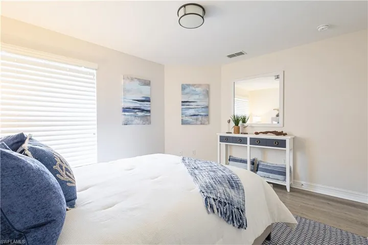 Bedroom featuring wood finished floors and baseboards