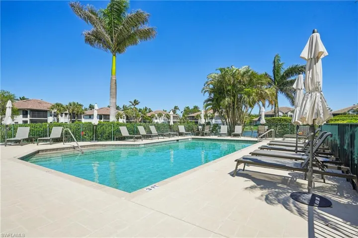 Community pool featuring a patio area and a residential view