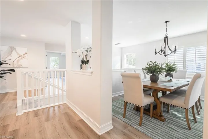 Dining area featuring light wood-type flooring and hanging lights