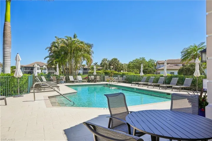 Community pool featuring a patio and a residential view