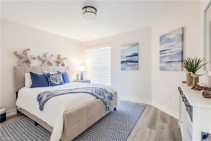 Bedroom with light wood-type flooring and baseboards