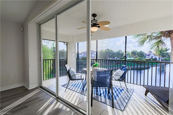 Sunroom featuring baseboards and wood finished floors