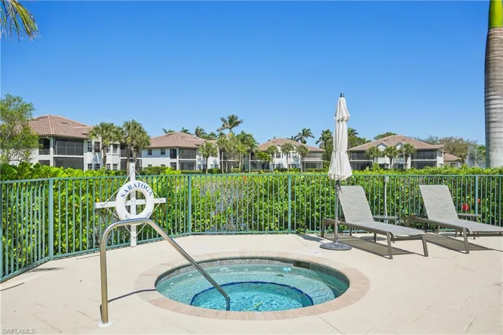 View of pool with a hot tub and patio surround