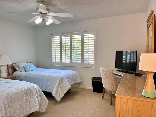 Twin Beds with a desk area and TV