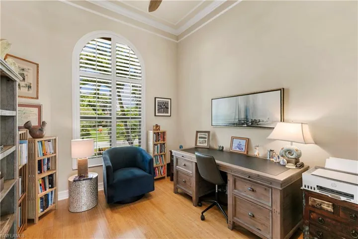 Natural wood floors in the den, custom plantation shutters