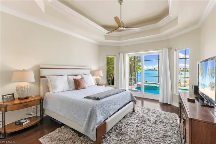 Gorgeous primary suite with natural dark wood flooring