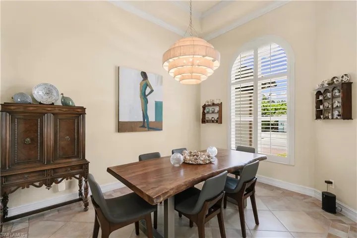 Bright formal dining area, custom plantation shutters