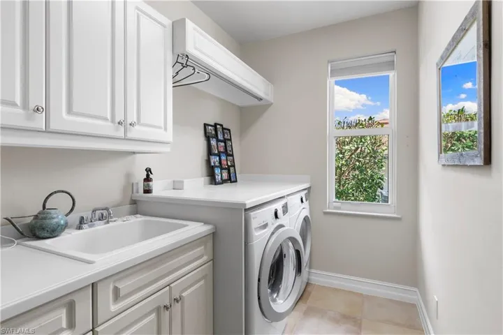 Laundry area with sink, plenty of storage, and more