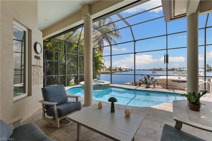 Spacious pool area with covered seating area and open seating area