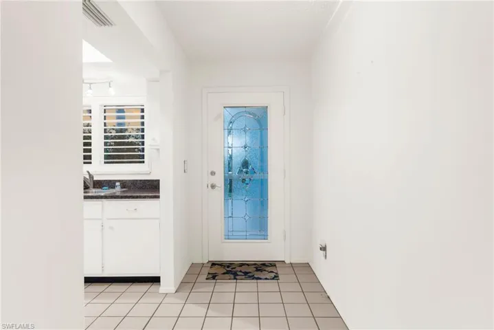 Foyer entrance featuring light tile patterned flooring