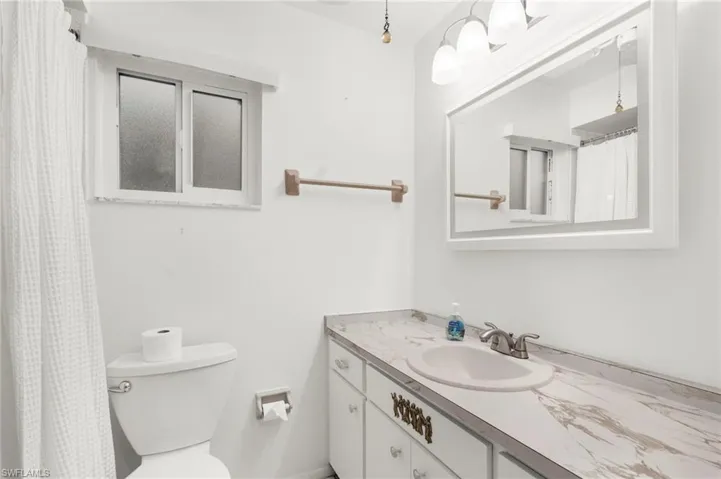Bathroom with vanity and curtained shower