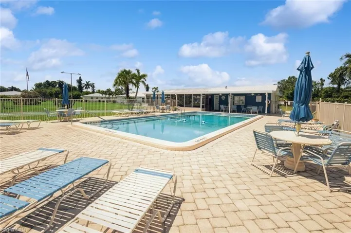 Community pool with a patio