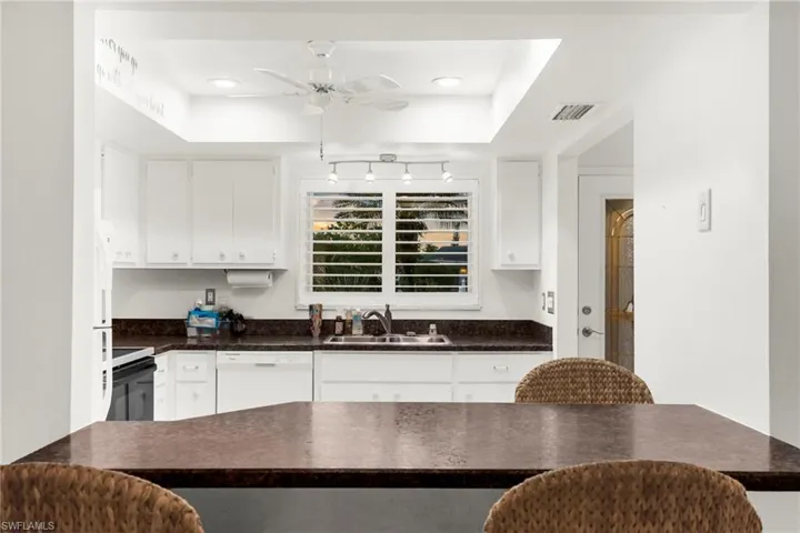 Kitchen featuring white cabinetry, white dishwasher, range with electric stovetop, a ceiling fan, and recessed lighting