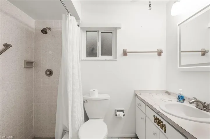 Bathroom with vanity and a tile shower