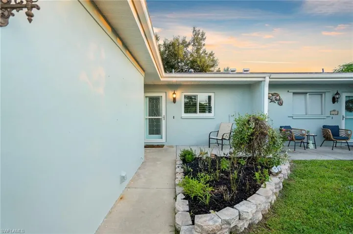 Property entrance featuring stucco siding and a patio