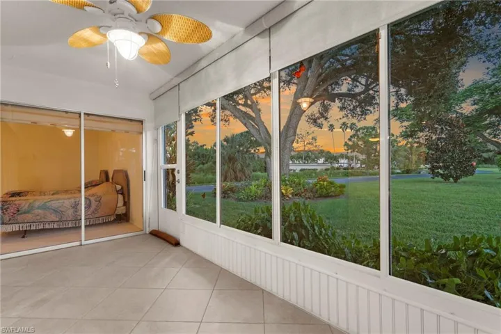 Unfurnished sunroom with a water view and ceiling fan