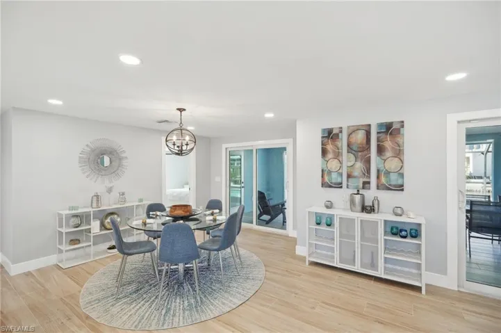 Dining area with recessed lighting, light wood-type flooring, a chandelier, and healthy amount of natural light