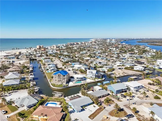 Aerial view of residential area featuring a large body of water