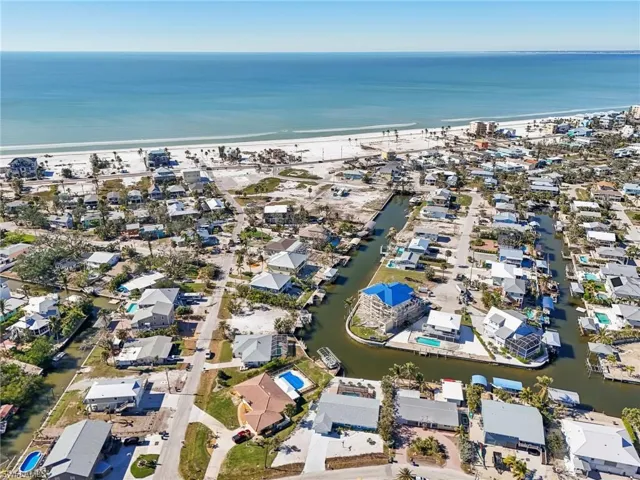 Aerial overview of property's location featuring a large body of water and nearby suburban area