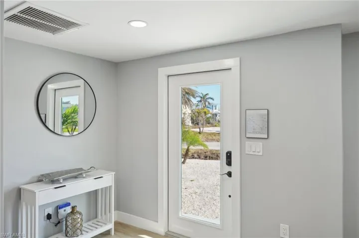Entryway featuring healthy amount of natural light, recessed lighting, and wood finished floors