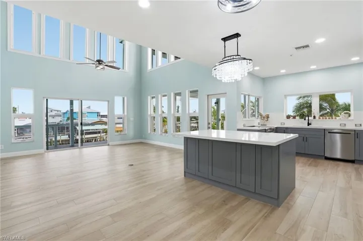 Updated kitchen and living area with 24 ft ceilings - virtually enhanced