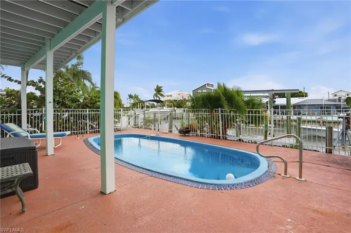 View of pool featuring a patio area - virtually enhanced