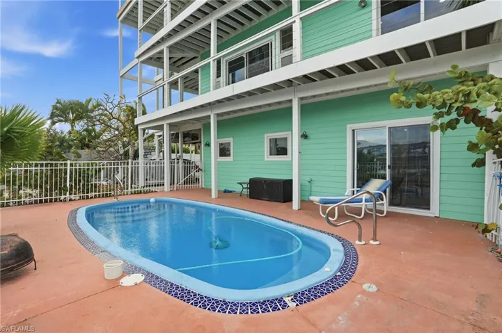 View of swimming pool with a patio area and a balconies - virtually enhanced