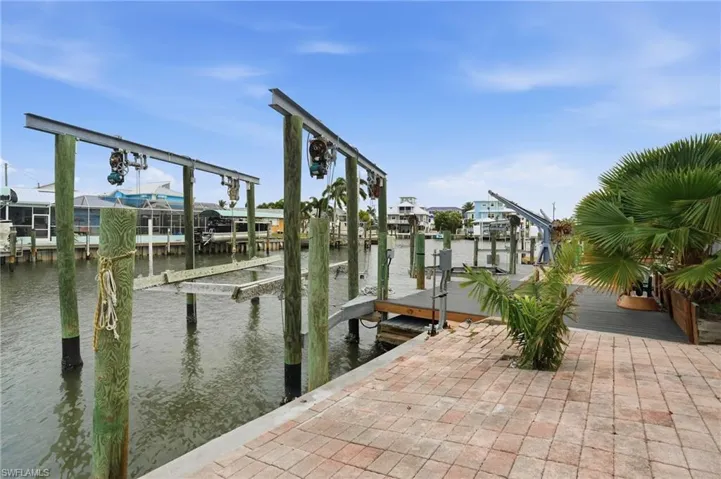 Dock with boat lift and canal view - virtually enhanced