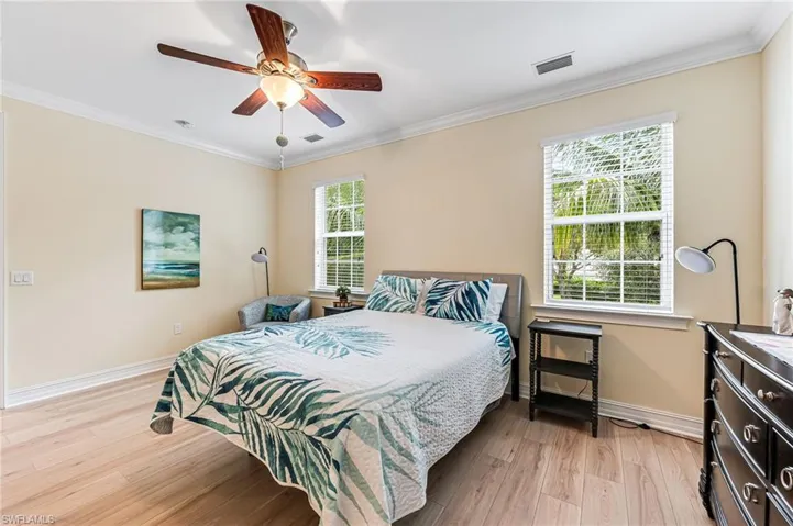 Master Bedroom featuring ceiling fan, multiple windows, and light wood-type flooring