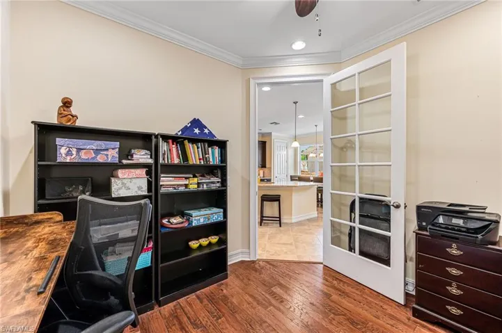 Office area featuring ceiling fan, tile flooring, french doors, and ornamental molding