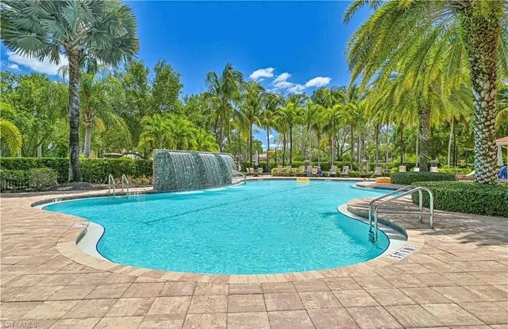 View of pool with a patio and pool water feature