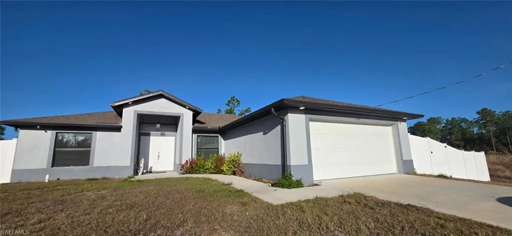 Single story home with stucco siding, concrete driveway, an attached garage, and a shingled roof