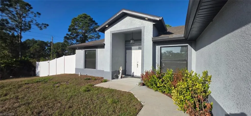 Doorway to property featuring stucco siding
