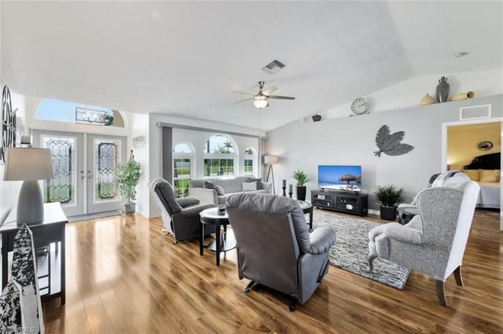 View of Greatroom Tasteful furnishings to Front Etched Double Door Enter and Half Moon Windowing