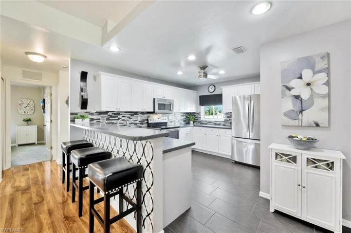 View of Efficient Kitchen and Hallway to Second-Third Bedroom and Bath