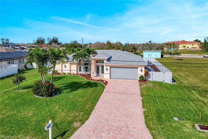 View of Front Elevation with Landscaped Circle from Paver Driveway