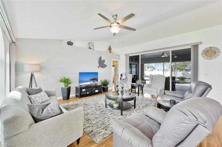 View of Greatroom tasteful Furnishings and Slider to Lanai Under Truss