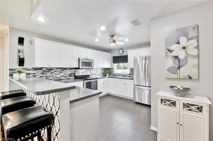 View of Efficient Kitchen Breakfast Bar into Kitchen with window