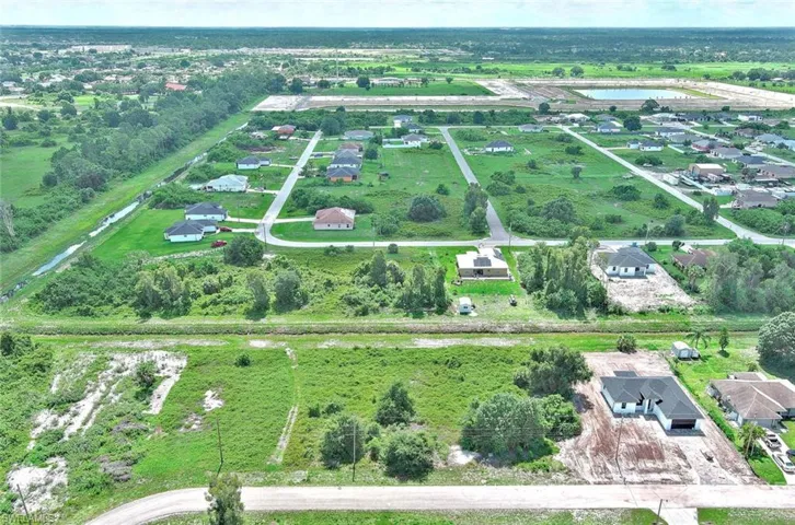 Aerial view of property's location featuring a large body of water