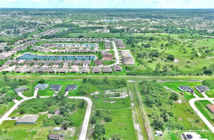 Aerial view of residential area featuring a large body of water