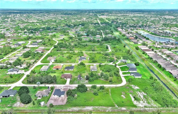 Aerial overview of property's location featuring nearby suburban area and a large body of water