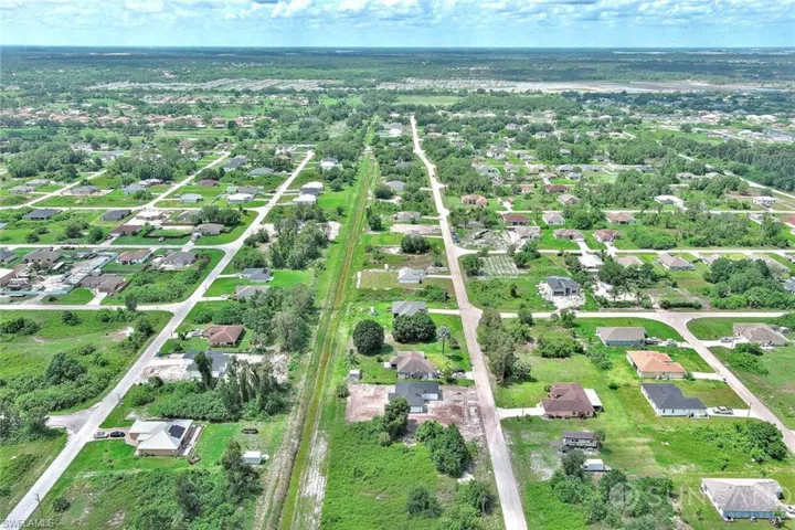Aerial view of property's location with nearby suburban area