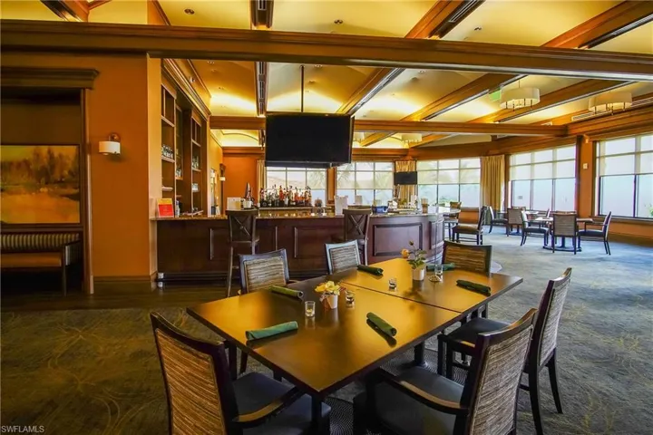 Dining area with Beam Ceiling and carpet