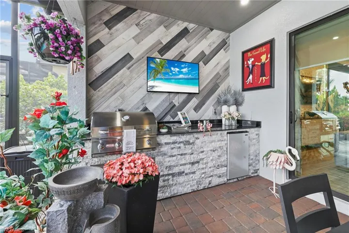 Bar with stainless steel fridge and tile walls