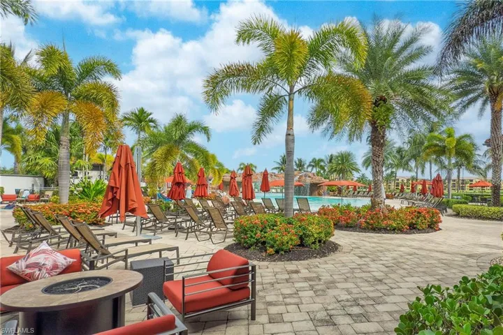 View of community pool featuring a fire pit