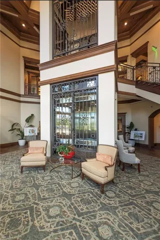 Building lobby featuring crown molding, a high ceiling, coffered ceiling, and beam ceiling