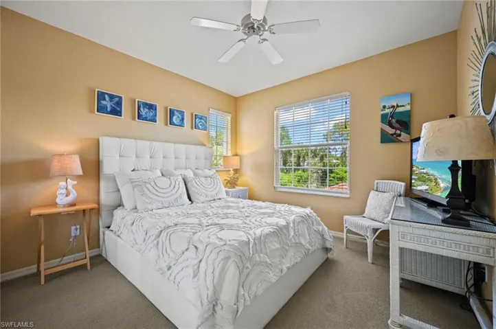Carpeted bedroom with ceiling fan