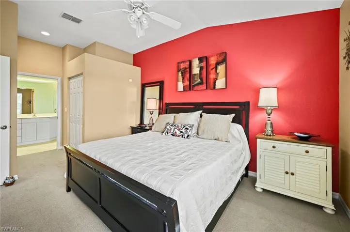 Bedroom with carpet floors, a closet, ceiling fan, and ensuite bathroom