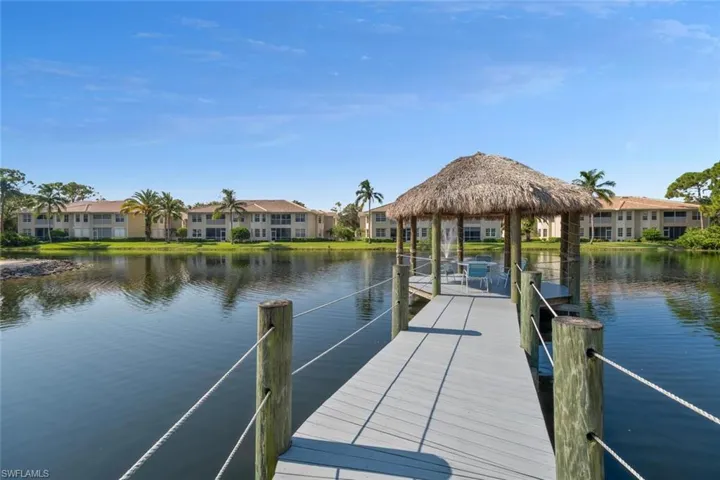 View of dock featuring a gazebo and a water view